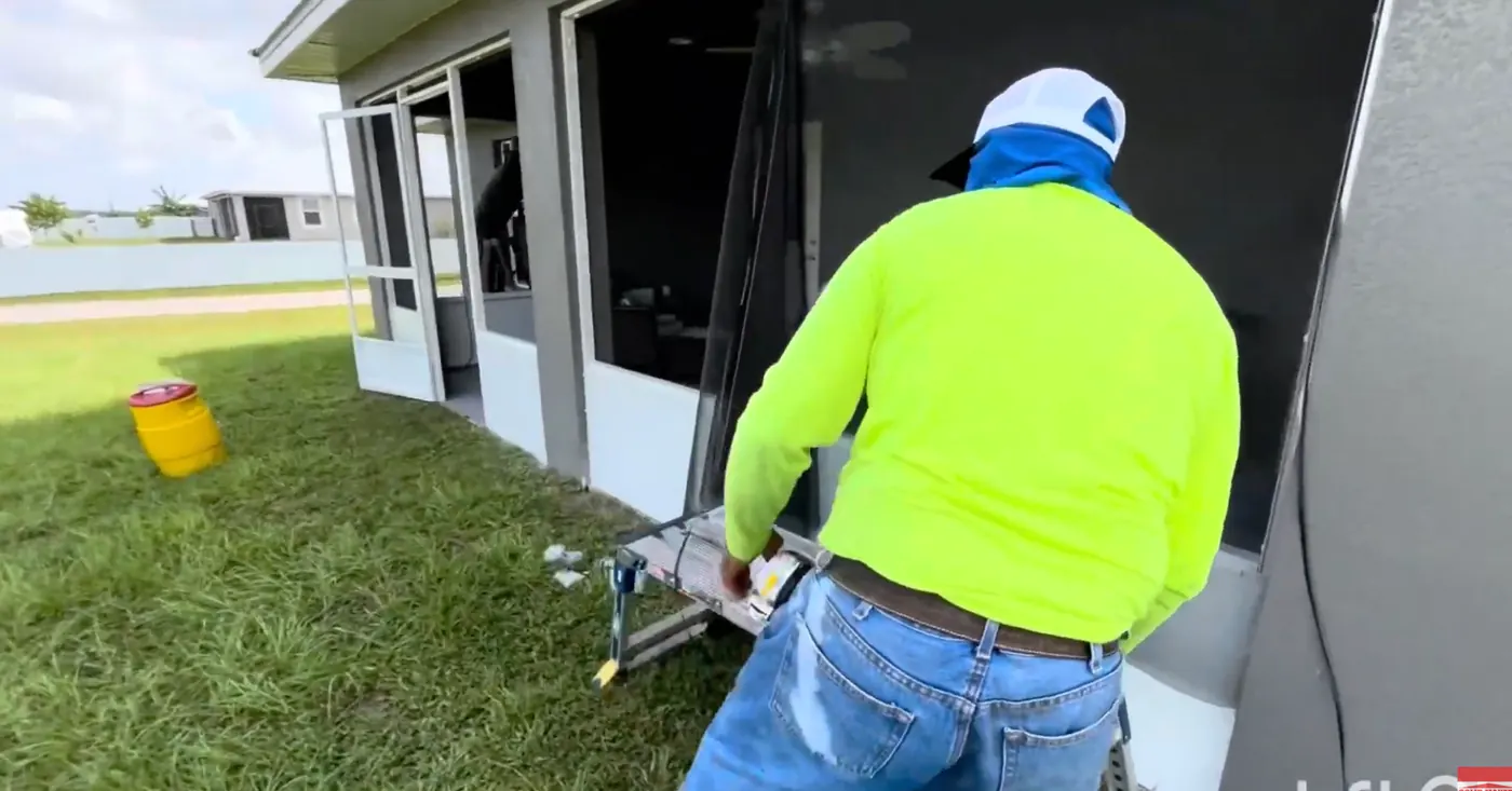 Solid Makers crew installing screen on a lanai enclosure in Banyan Village near LaBelle Florida