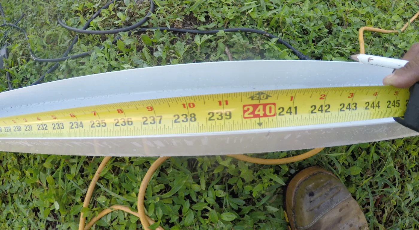 Measuring the aluminum header for insulated patio roof panels on a Clewiston Florida project