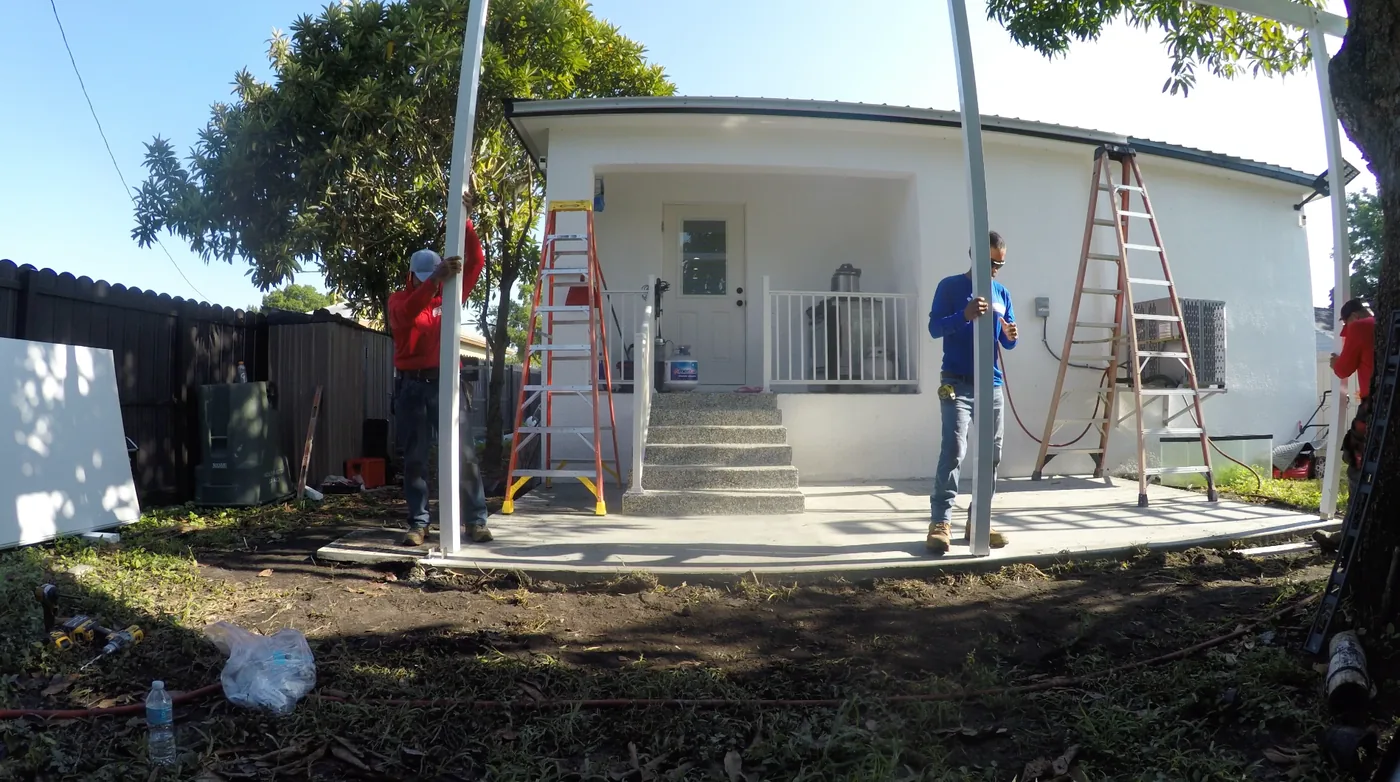 Solid Makers crew installing aluminum posts and framing for a patio roof in Clewiston Florida