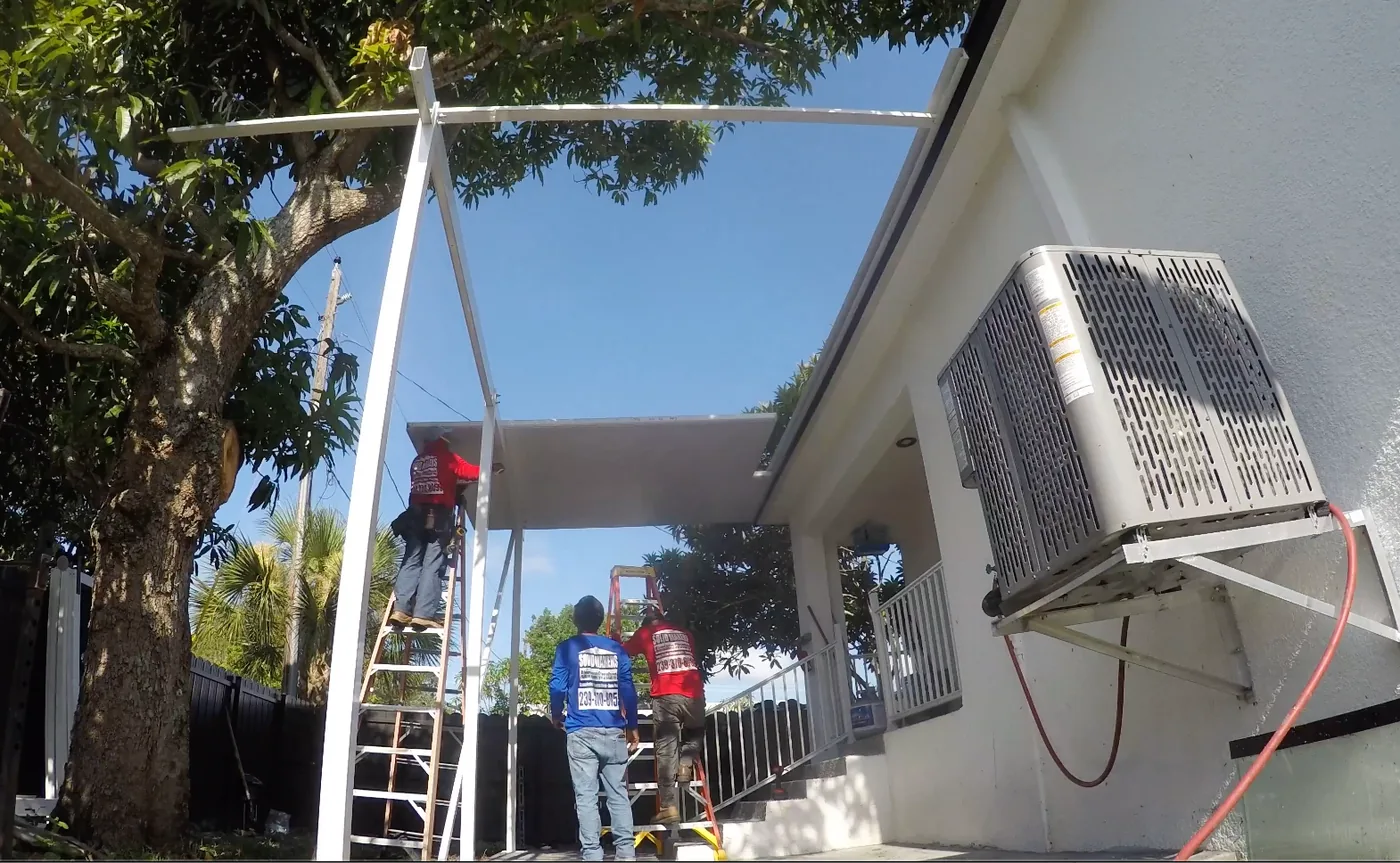 Solid Makers crew installing insulated aluminum patio roof panels in Clewiston Florida