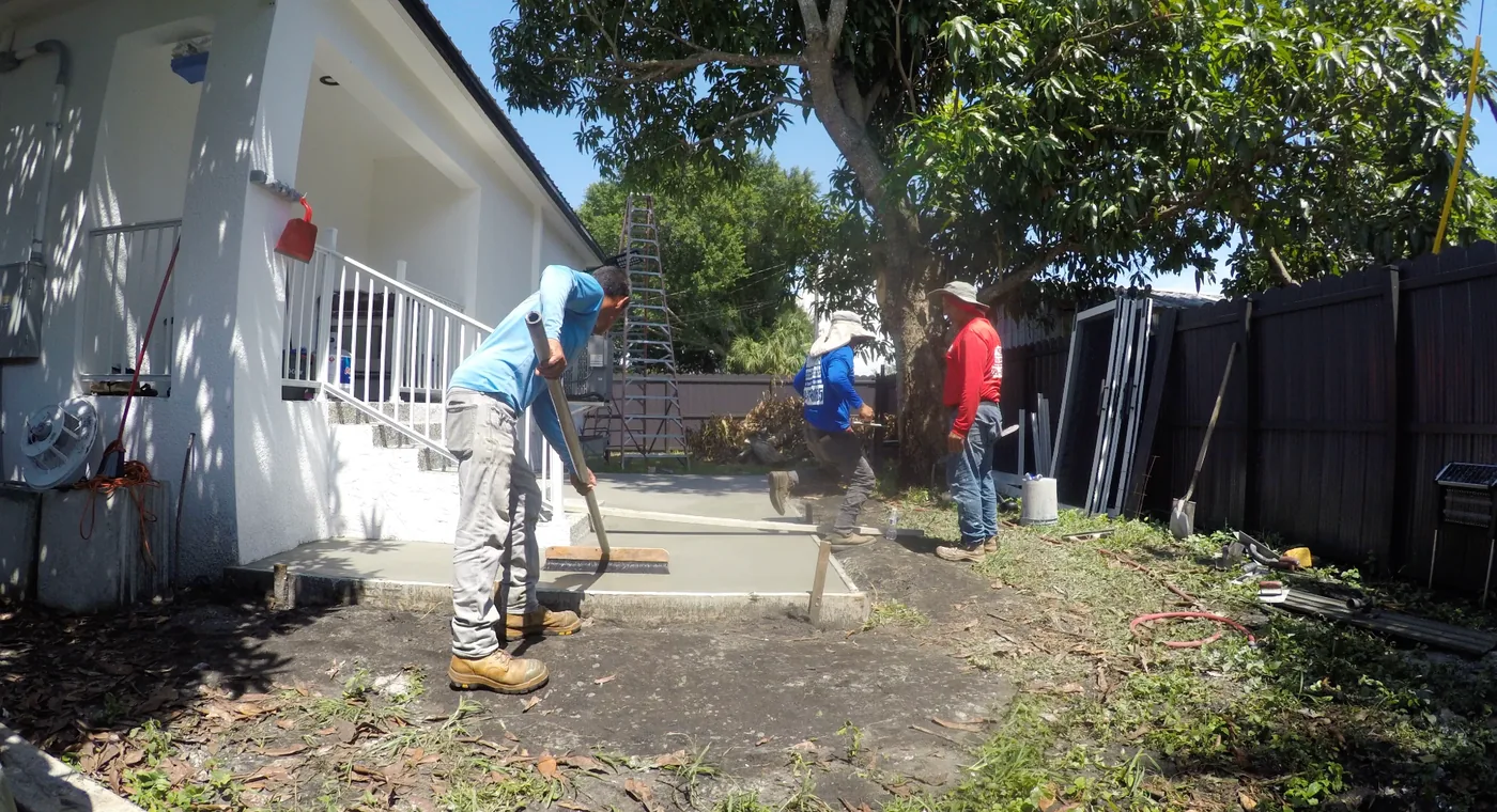 Solid Makers crew pouring and finishing a new concrete patio slab for an aluminum patio roof in Clewiston Florida