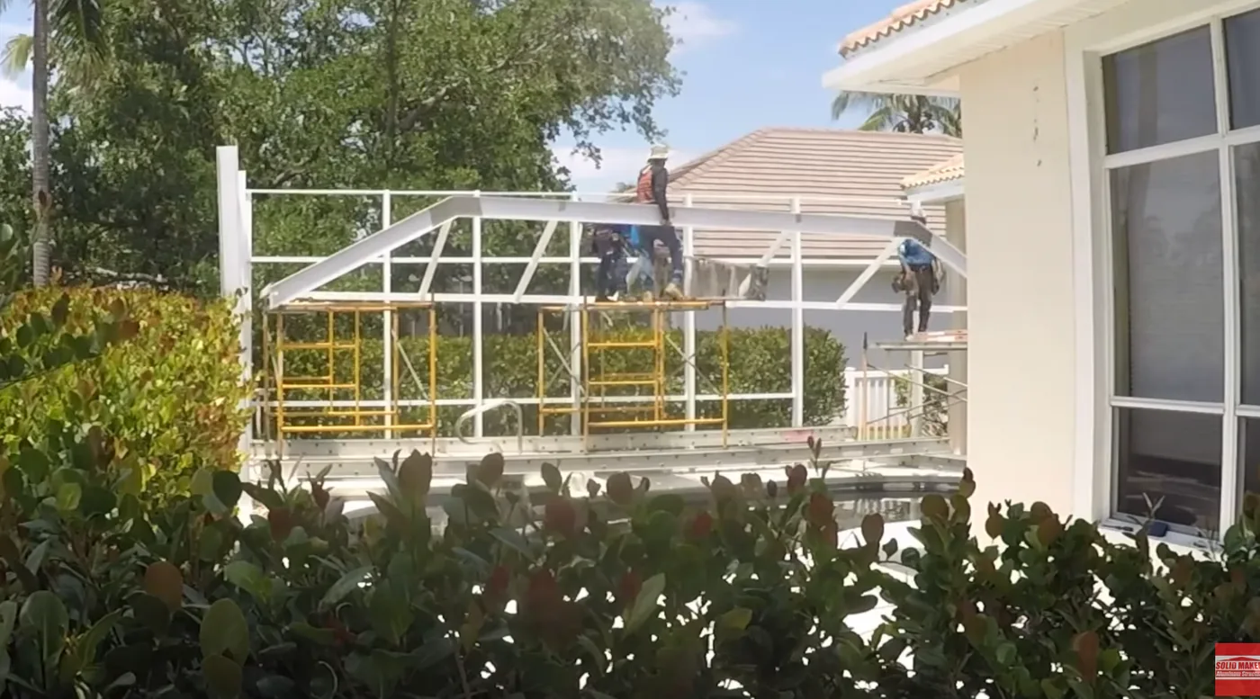 Solid Makers building the aluminum framing and roof structure for a pool screen enclosure in Fort Myers Florida