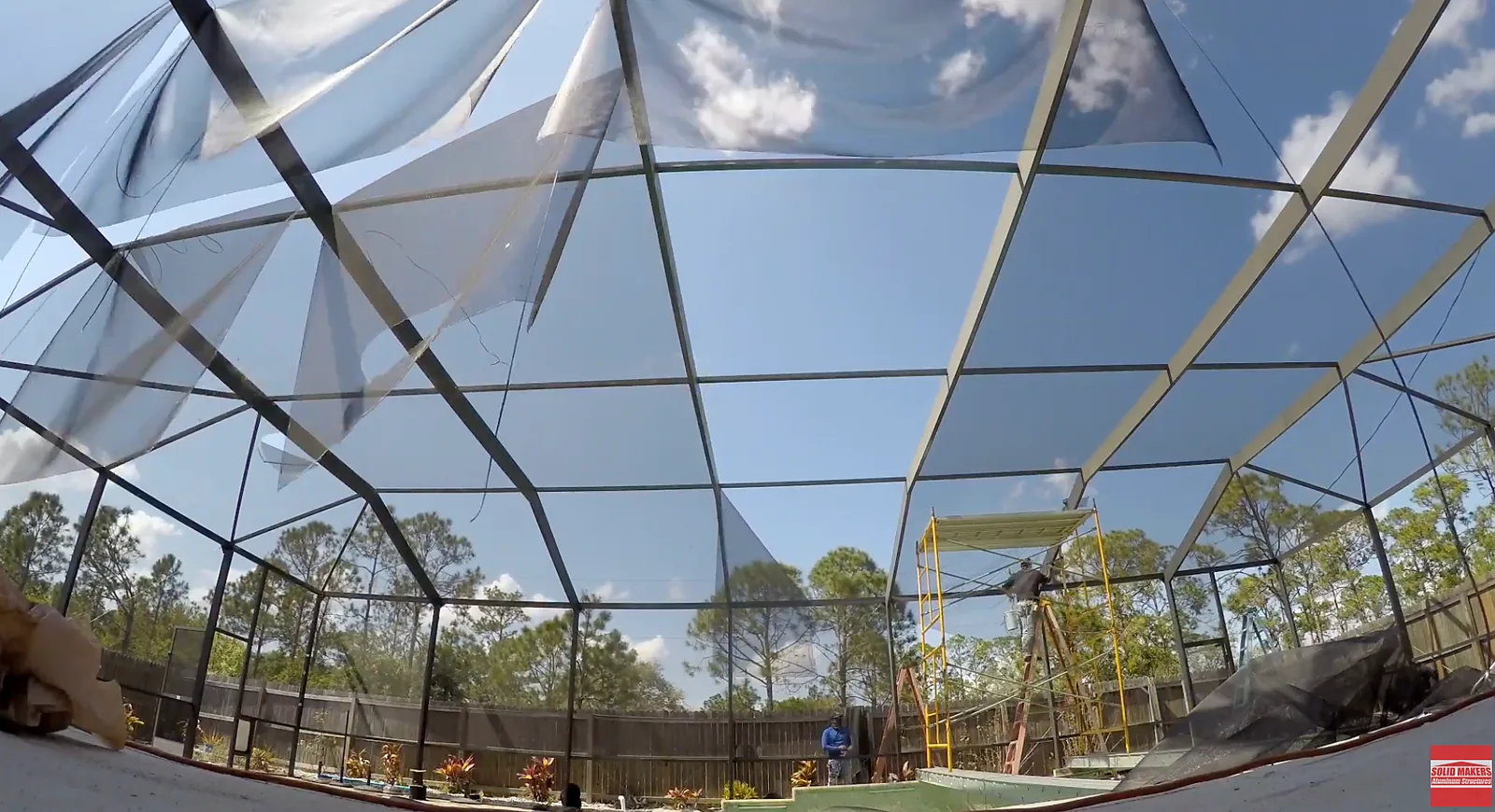 Upper pool cage screen panels being replaced during a full rescreen in Lehigh Acres Florida