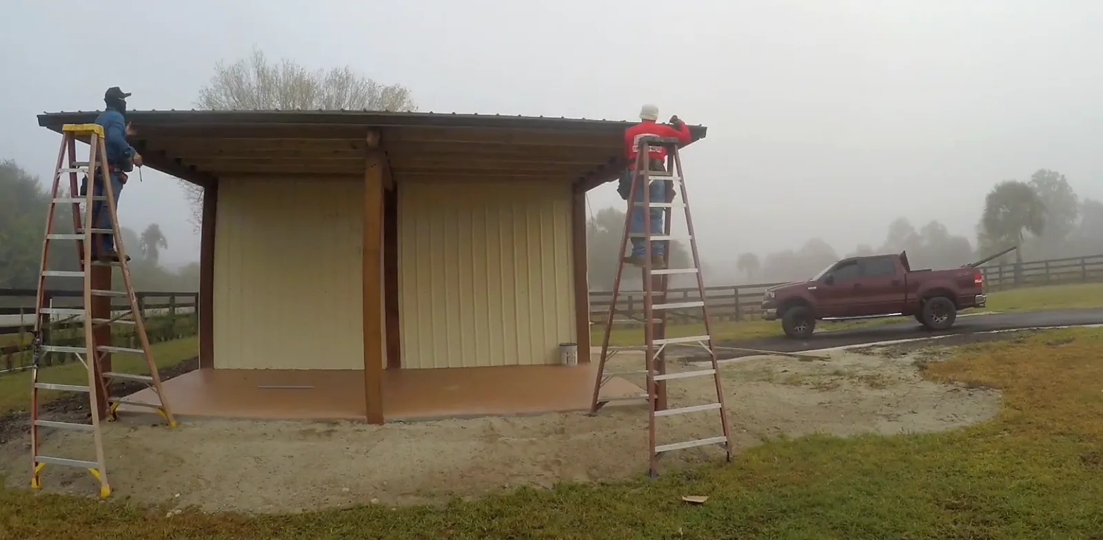 Solid Makers crew installing seamless gutters on a barn in Montura Florida near Clewiston