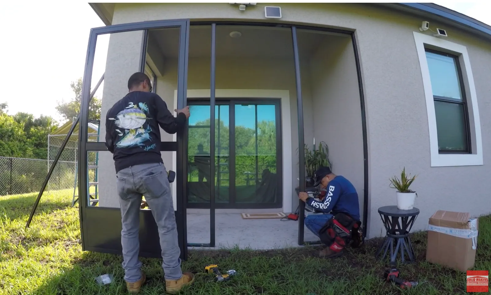 Installing bronze screen door and aluminum framing on a screen lanai in LaBelle Florida